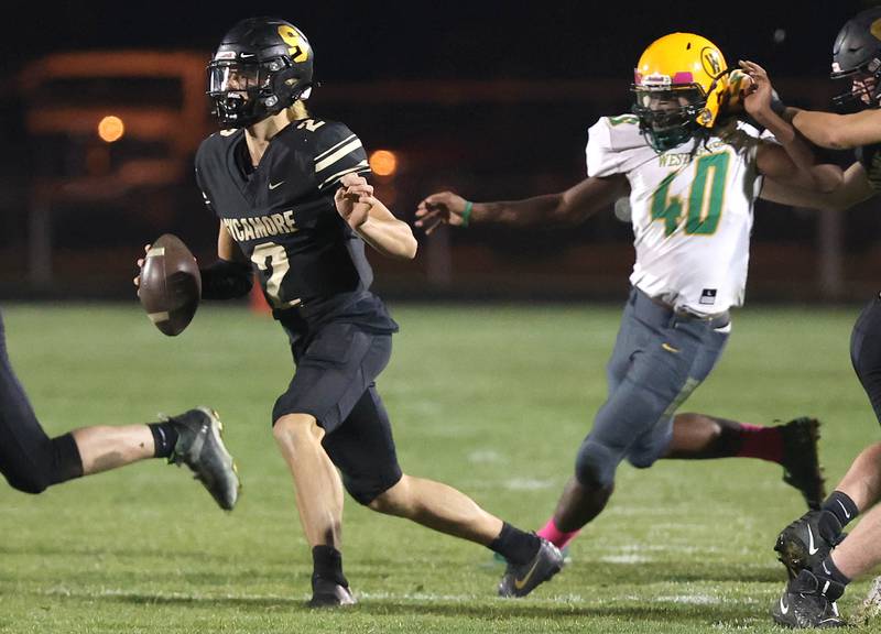 Sycamore's Elijah Meier scrambles away from the pressure of Westinghouse's Reginald Anderson during their first round playoff game Saturday, Oct. 29, 2022, at Sycamore High School.