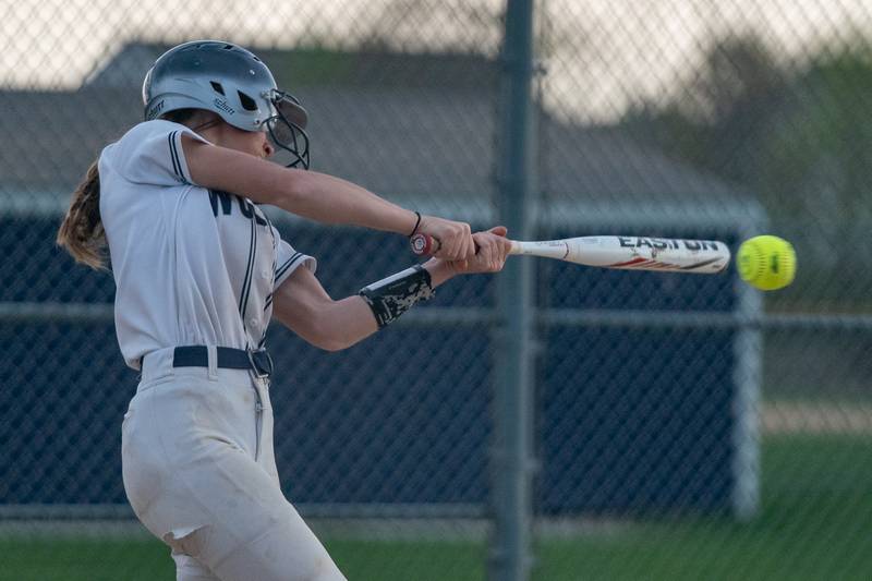 Oswego East's May Pasqualini (3) slaps a single against Oswego during a softball game at Oswego East High School on Wednesday, April 19, 2023.
