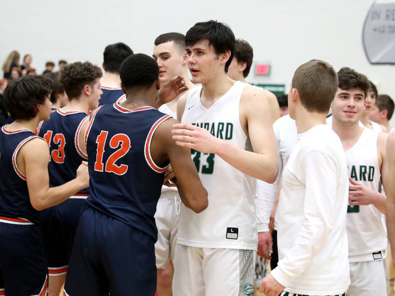 Glenbard West’s Bobby Durkin (33) hugs Naperville North’s Zeke Williams (12) following a Class 4A Bartlett Sectional semifinal game on Tuesday, March 1, 2022. Durkin and Williams are former youth team teammates.