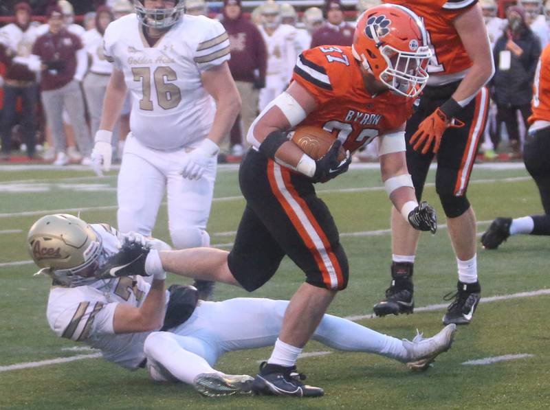 Byron's Caden Considine runs the ball as Mt. Carmel's Andrew Gillihan falls down behind during the Class 3A State football championship in November 2023 at Hancock Stadium in Normal.
