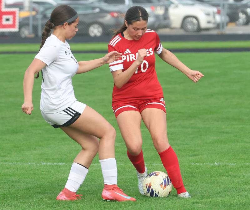 Ottawa's Brooklyn Byone keeps the ball away from L-P's Vizion Byrd on Monday, April 13, 2026 on King Field at Ottawa High School.