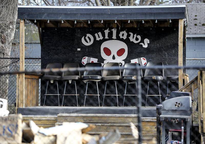 A painted Outlaws logo stands behind several seats Wednesday, Dec. 20, 2017, at the motorcycle club's clubhouse in Joliet, Ill.