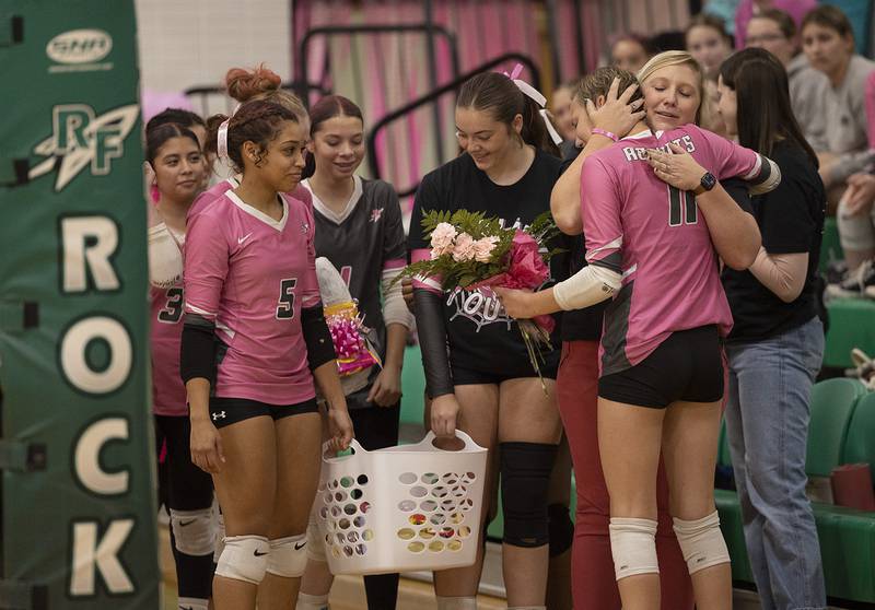 Rock Falls volleyball teammates hug and celebrate Maddie Eikenberry (right) during her fight against cancer Tuesday, Oct. 14, 2025.