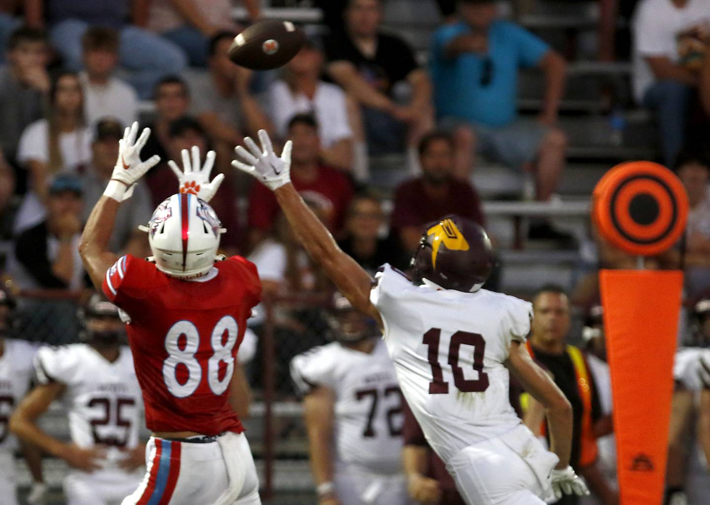 Marian Central's Christian Bentancur catches the ball behind Richmond-Burton's Max Loveall Bentancur  scored a touchdown on the play during a nonconference football game Friday, Aug. 25, 2023, at Marian Central Catholic High School.