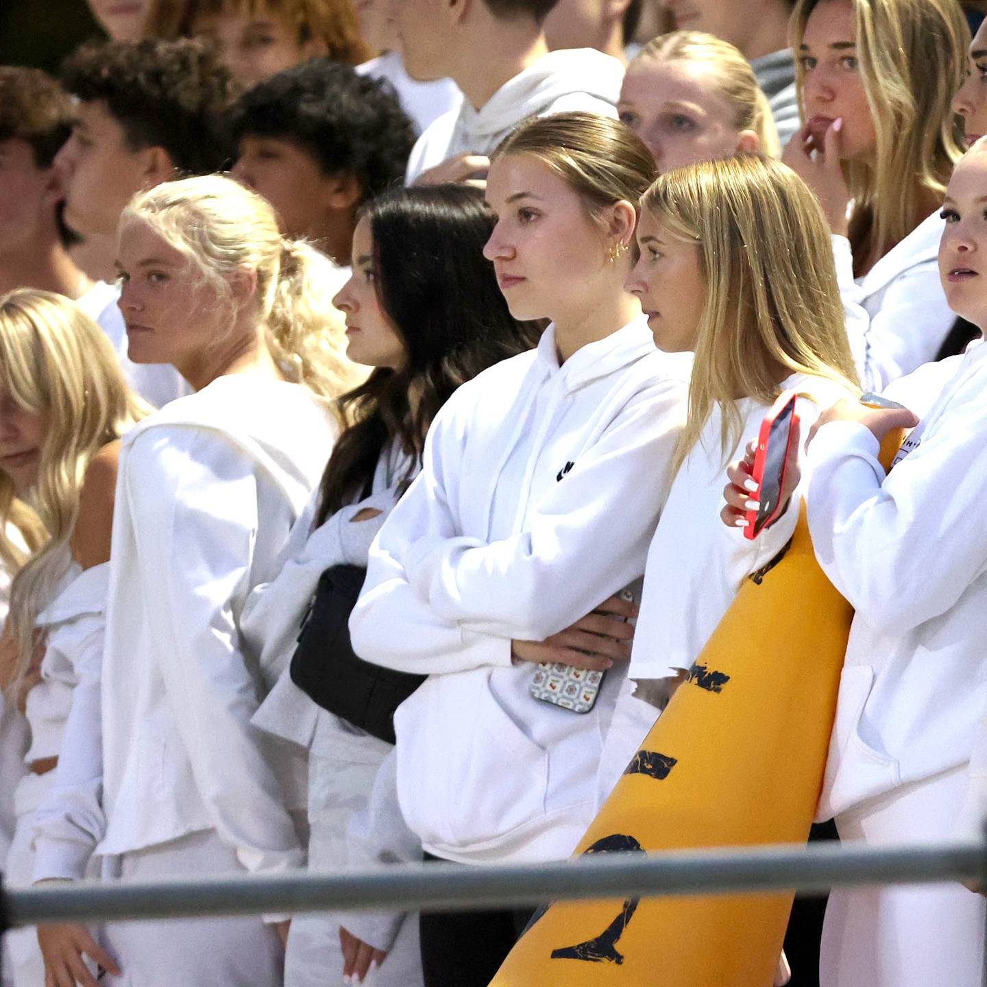 The Sycamore High School student section stands for a moment of silence before the football game Friday, Sept. 8, 2023, at Sycamore High School to honor the memory of a 17-year-old classmate who was stabbed to death Thursday, Sept. 7, 2023. Another high schooler, 15, is charged in the teen's death.