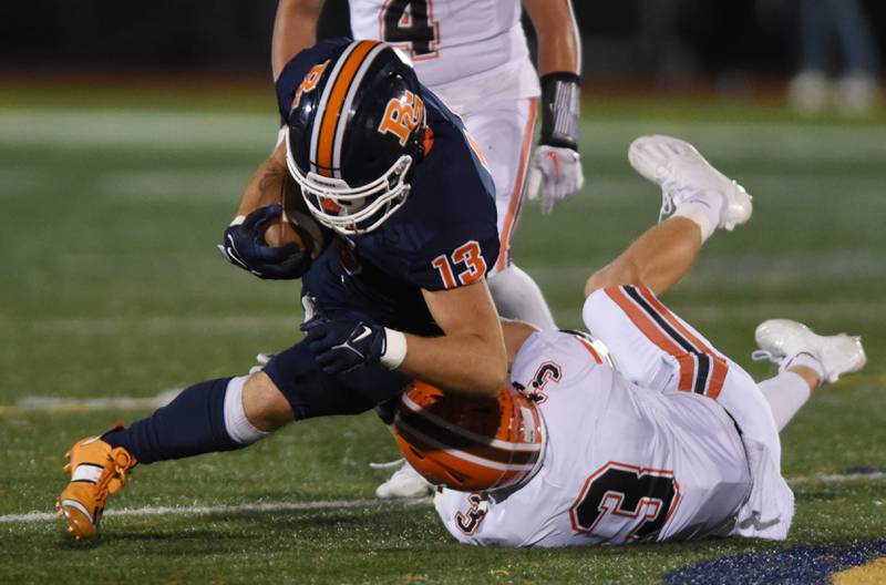 Joe Lewnard/jlewnard@dailyherald.com
Buffalo Grove’s Jakub Niedojadlo, left, gets tackled by Hersey’s Reese Settersten during Friday’s game in Buffalo Grove.