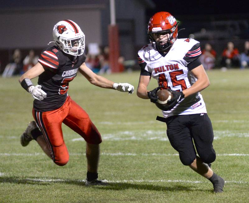Fulton's Blaze Damhoff (45) runs with the ball as Foreston's Joseph Kobler (5) looks to tackle during a Friday, Sept. 12, 2025 in Forreston.