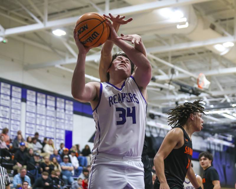 Plano's Kevin Martinez (34) is fouled under the basket during their basketball game between Sandwich at Plano Tuesday, Dec 9, 2025 in Plano.