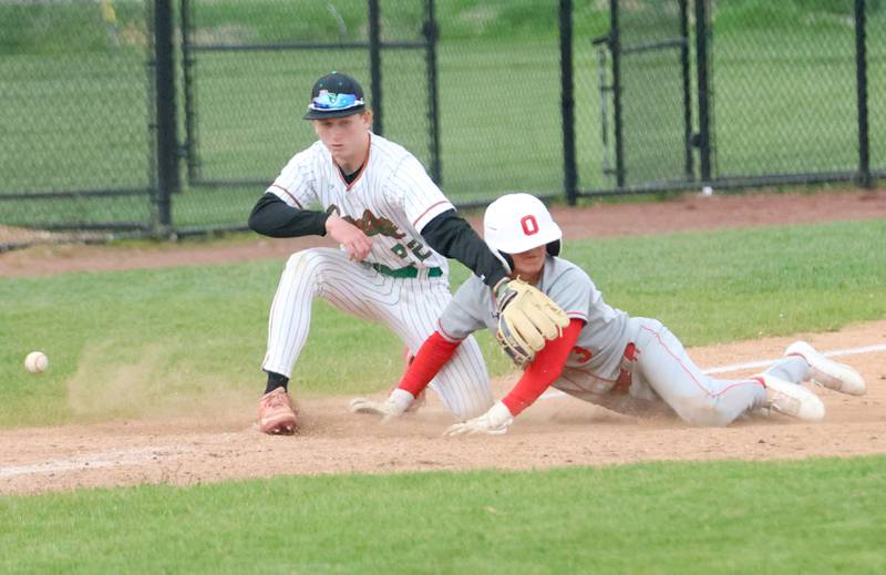 Ottawa's Rory Moore slides into third base after hitting a triple as the ball arrives late to L-P's Brendyn Fuchs on Thursday, April 30, 2026 at Huby Sarver Field in the L-P Athletic Complex in La Salle.