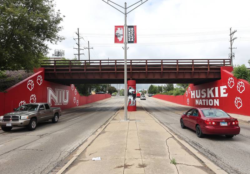 Vehicles drive by the new Huskie mural Monday, Aug. 14, 2023, on the Annie Glidden Road railroad underpass, just south of Lincoln Highway in DeKalb. The mural was a joint project between the City of Dekalb and Northern Illinois University.