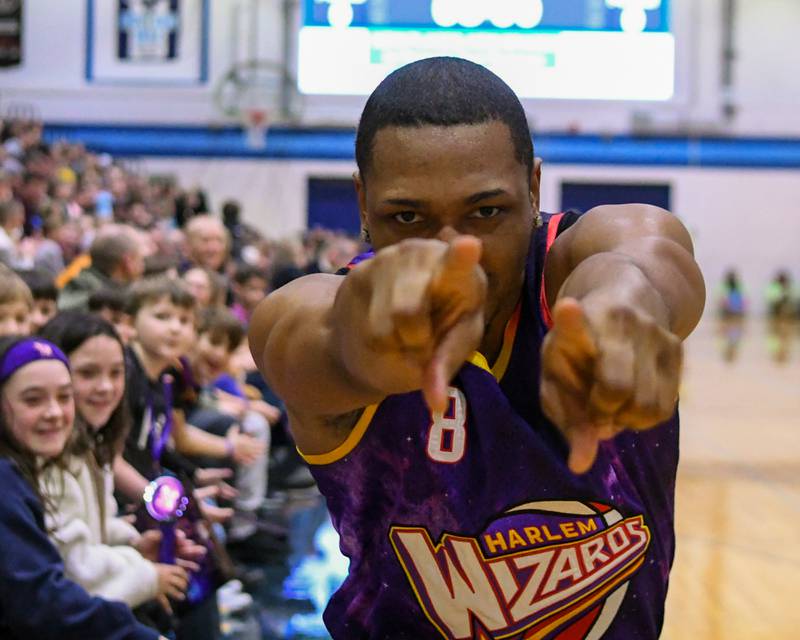 Harlem Wizard player Livewire plays up the camera as he gets introduced before the start of the game on Sunday Jan. 19, 2025, held at Downers Grove South High School.