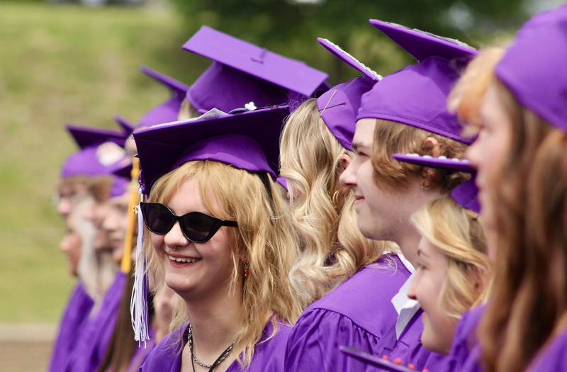 Members of the Class of 2023 talk to each other as the processional continues on Sunday, May 28, 2023, at Dixon High School.