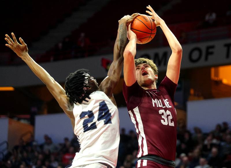 Oswego East's Mekhi Lowery blocks a shot by Moline's Owen Freeman, who got the foul call in his favor, during the first half of their IHSA supersectional game on Monday.   (Photo: PhotoNews Media/Clark Brooks)