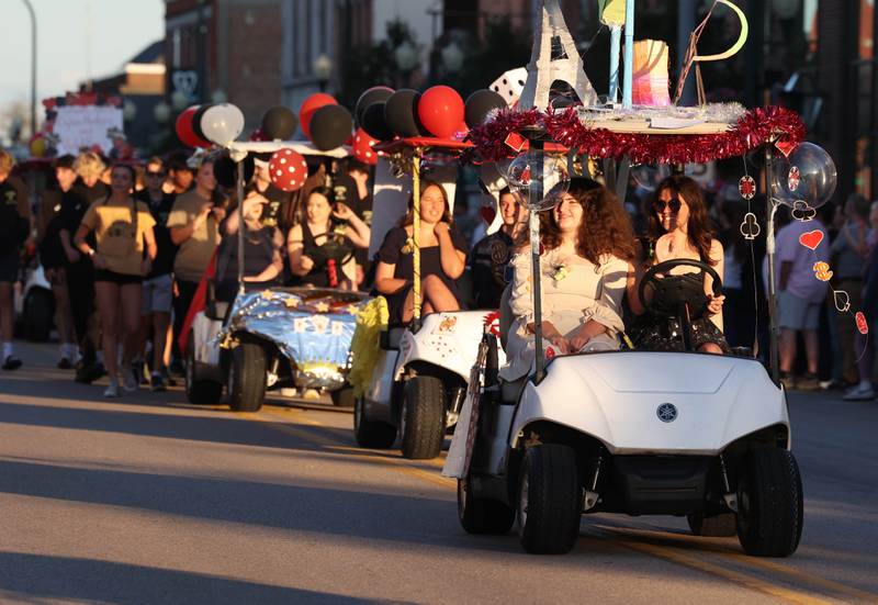 Some of the golf carts decorated by the various school clubs head down State Street Wednesday, Sept. 25, 2024, during the Sycamore High School homecoming parade.