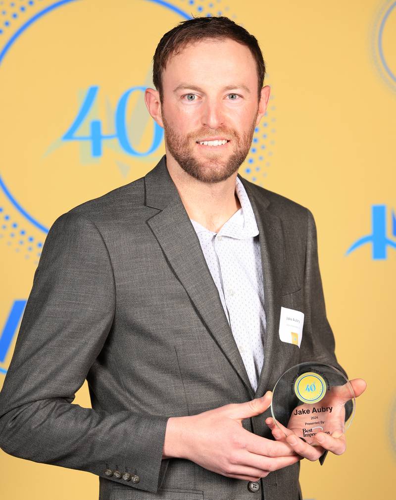 Jake Aubry poses with his 40 Under Forty award during the Illinois Valley Chamber of Commerce Champions of Change Awards Night on Thursday, April 10, 2025 at the Westclox Event Center in Peru.