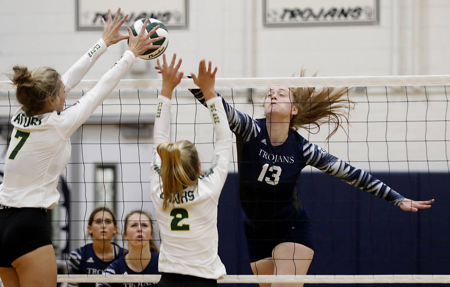 Crystal Lake South’s Gabby Wire, and Kendall Brandt, center, tries to block the spike of Cary-Grove’s Tricia Kennedy during a Fox Valley Conference volleyball match Thursday, Aug. 25, 2022, between Cary-Grove and Crystal Lake South at Cary-Grove High School.