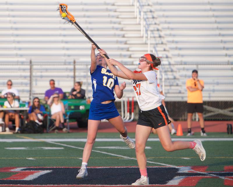 Crystal Lake Central's Anna Starr battles for the ball with Lake Forest's Maeve Farrell at the Super Sectional Final on Tuesday, May 30, 2023 in Huntley.