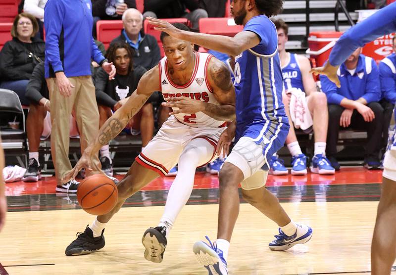 Northern Illinois Huskies guard Zarique Nutter goes baseline against Buffalo Bulls forward Isaiah Adams Tuesday, Feb. 28, 2023, during their conference matchup at the Convocation Center at NIU.