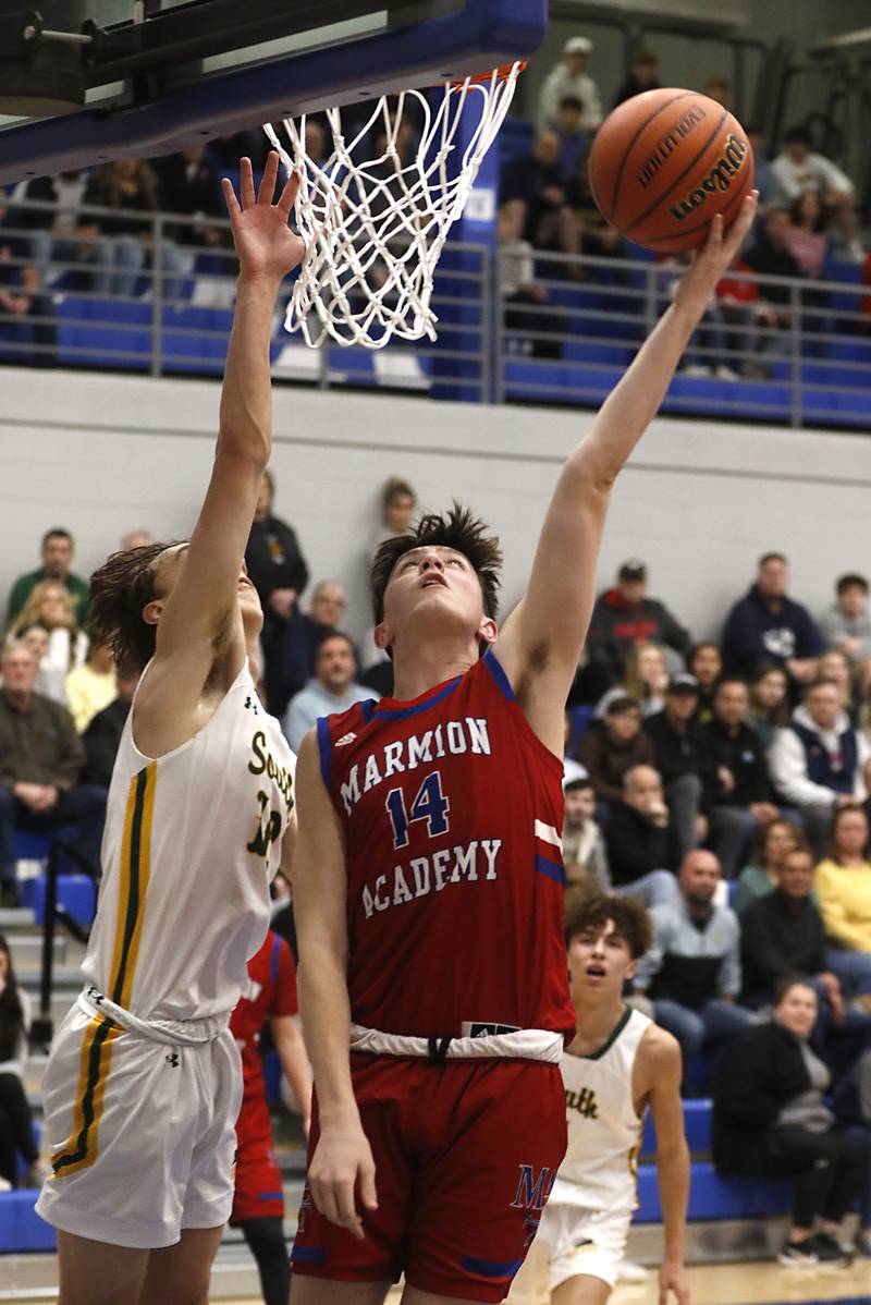 Marmion’s Evan Stumn drives to the basket against Crystal Lake South's Cam Miller during a IHSA Class 3A Sectional boys basketball game Tuesday, Feb. 28, 2023, at Central High School in Burlington.