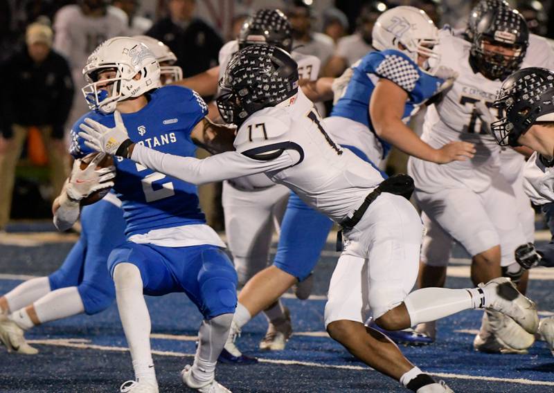 St. Francis' Adam Criter (2) tries to spin out the tackle from IC Catholic Prep's Antonio Richardson (17) during the first half of a game in Wheaton on Friday, October 22, 2021.