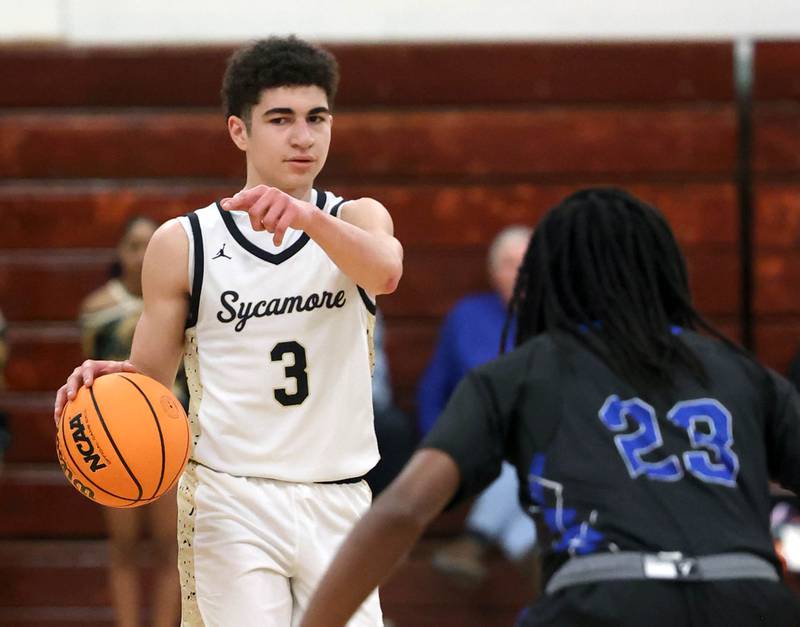 Sycamore's Marcus Johnson brings the ball up against Woodstock's Marc Thomas Friday, Feb. 27, 2026, during their IHSA Class 3A boys basketball regional championship game at Boylan Catholic High School in Rockford.