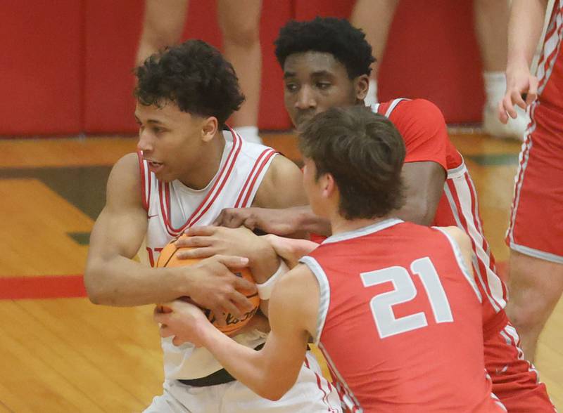Ottawa's Hezekiah Joachim wins a jump ball over Streator's Sharonn Morton and Joseph Hokestra during the Class 3A Regional semifinal game on Wednesday, Feb. 25, 2026 in Sellett Gymnasium at L-P High School.