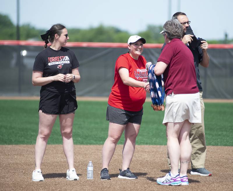 The Forreston Cardinals head coach Kim Snider accepts her medal after her team took the win at the state tournament 4-2 in 8 innings against Newark Saturday, June 4, 2022 during the IHSA Class 1A softball state third place game.