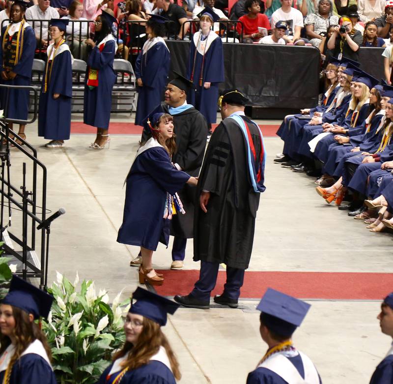 An excited Oswego High School graduate shakes hands with  Dr. Andalib Khelghati, Superintendent of Schools for District 308 at the Oswego High School Class of 2024 Commencement Ceremony on Saturday, May 18, 2024 in DeKalb.