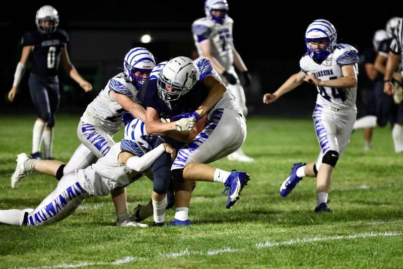 Tigers gang up on a Monmouth-Roseville ball carrier Friday night. Princeton won 40-0.