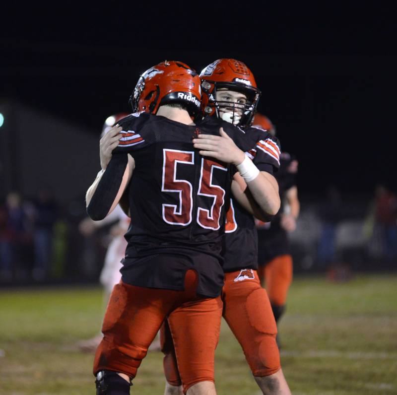 Fulton's Ben Huisenga (23) a sophomore embraces Josiah Heald (55) a senior after defeating Morrison on Friday, Oct. 25, 2024 in Fulton on Senior Night.