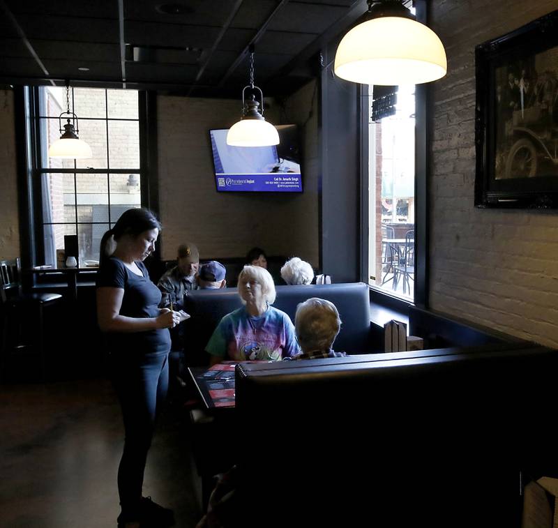 Jennifer Ostler waits on diners on Tuesday, Nov. 12, 2024, at Squire on the Square in Woodstock. 

The restaurant, which has similar decor as other Village Squire restaurants, is a joint venture between the Linardos family and Bob Karas of Karas Restaurant Group.
Squire on the Square is located in the basement of the Old Courthouse in Woodstock, and its menu will features items similar to the Linardos family’s restaurants and the Village Squire.  

The eatery replaces the Public House that closed at the end of March.