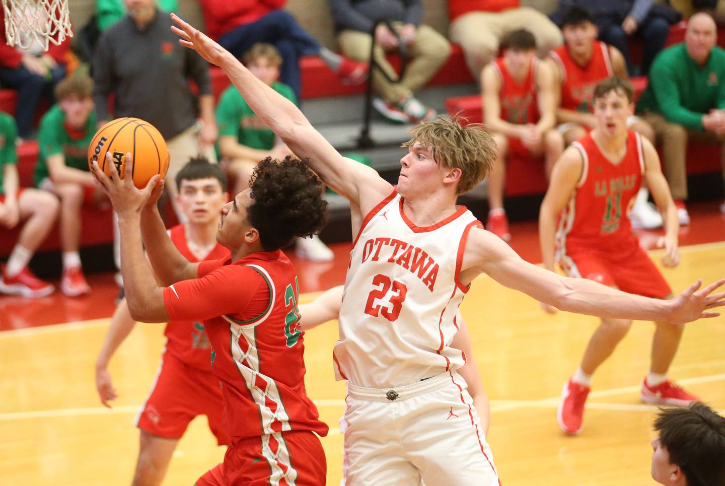 L-P's Marion Persich drives to the hoop as Ottawa's Owen Sanders defends on Friday, Jan. 10, 2024 in Kingman Gym at Ottawa High School.