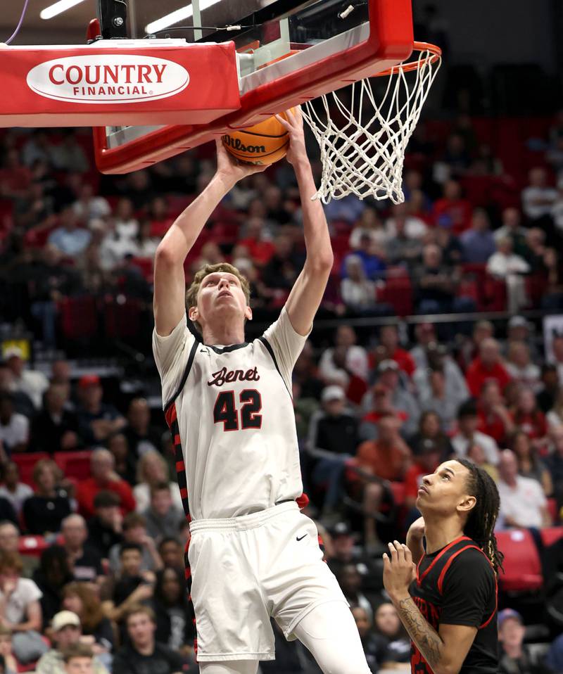 Benet’s Colin Stack scores in front of Auburn's Kaidan Dozie Monday, March 9, 2026, during their IHSA Class 4A supersectional matchup in the Convocation Center at Northern Illinois University in DeKalb.