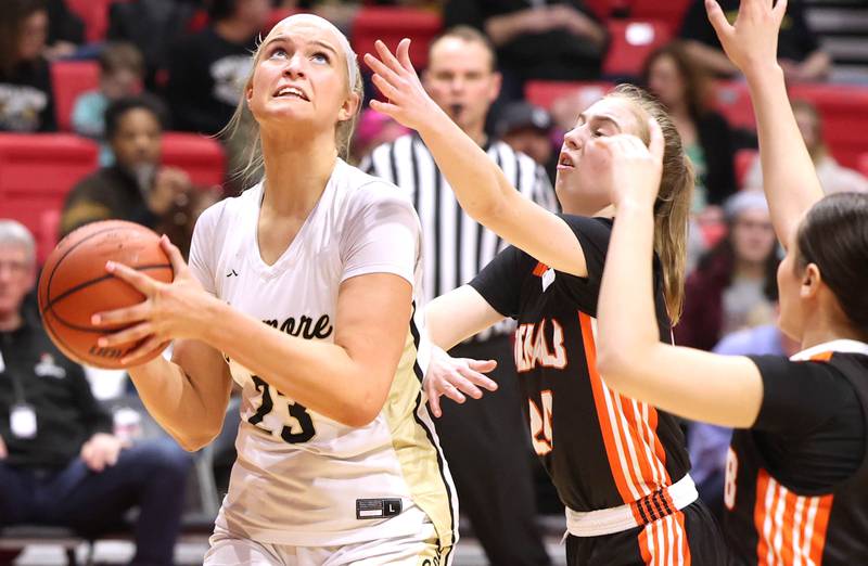 Sycamore's Evyn Carrier shoots in front of DeKalb's Olivia Schermerhorn during the First National Challenge Friday, Jan. 27, 2023, at The Convocation Center on the campus of Northern Illinois University in DeKalb.