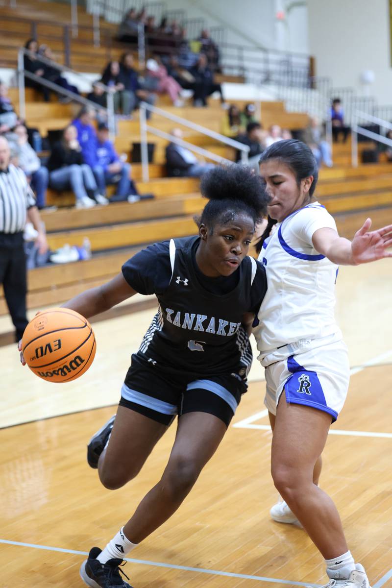 Kankakee's London Stroud drives against Rosary's Kayla Garcia during the Kays' 75-28 victory over Rosary at the Reed-Custer Classic on Monday, Nov. 17, 2025.