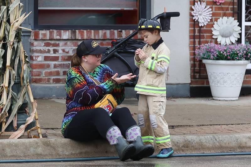Brie Chellino and her son Philip Moy wait for the start of the Kiddie Water Fight at the 75th Annual Grundy County Corn Festival on Saturday, Sept. 28, 2024 in downtown Morris.