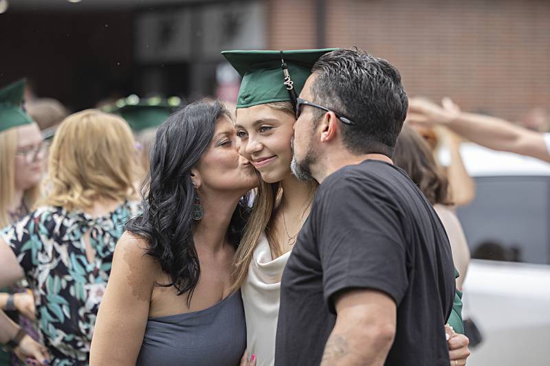 Grace Rippy is kissed by mom Jessica Walters and dad Randy Rippy Jr. following graduation at RFHS Sunday, May 28, 2023.