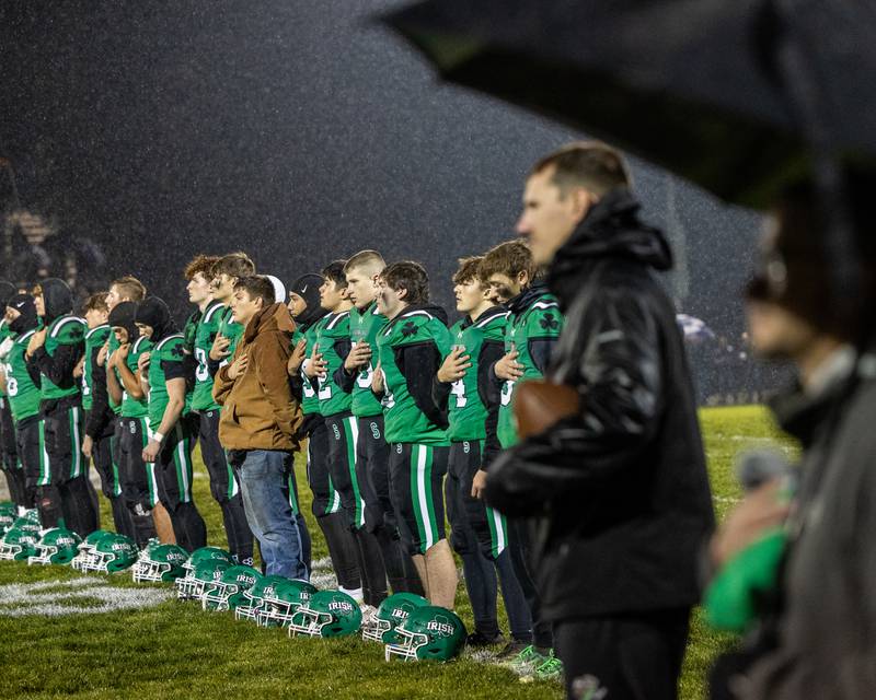Seneca players stand for national anthem in pouring rain on Saturday, November 8, 2025 at Seneca High School in Seneca.