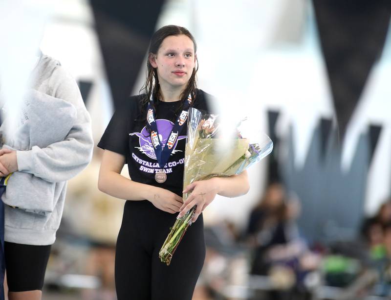 Crystal Lake co-op’s Isabella Fontana collects her medal following the 200-yard freestyle consolation heat during the IHSA Girls State Championships on Saturday, Nov. 16, 2024 at FMC Natatorium in Westmont.