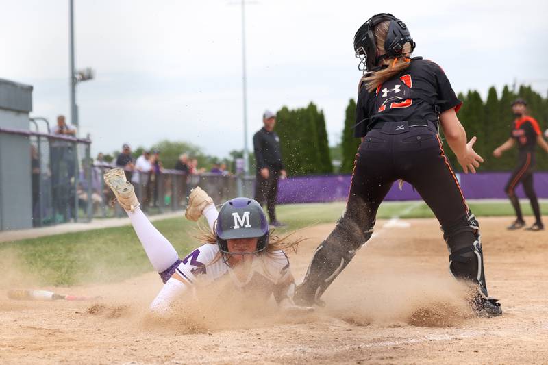 Manteno's Aubrie Goudreau dives at home plate to score during Beecher's 14-6 victory over Manteno in the Class 2A Manteno Regional championship on Friday, May 22, 2026.