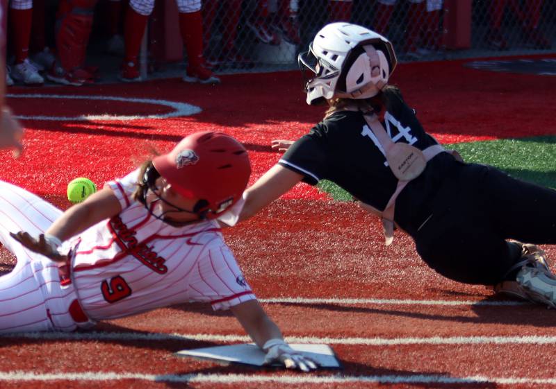 Huntley’s Madison Rozanski, right, fields the cutoff throw as Barrington’s Nina Brebach arrives safe at home in IHSA Class 4A Sectional Title Game softball action at the Fields of Dreams on the campus of Barrington High School in Barrington on Friday, June 6, 2025.