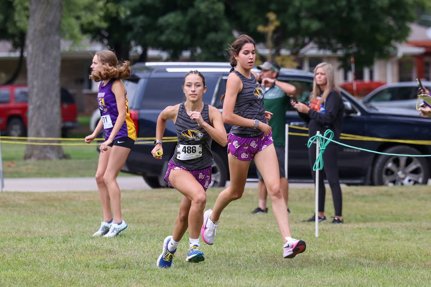 Herscher's Sophie Venckauskas takes off after receiving the baton from teammate Kelly O’Connor during the Irish Conditioner at Small Memorial Park in Kankakee on Wednesday, Sept. 3, 2025.