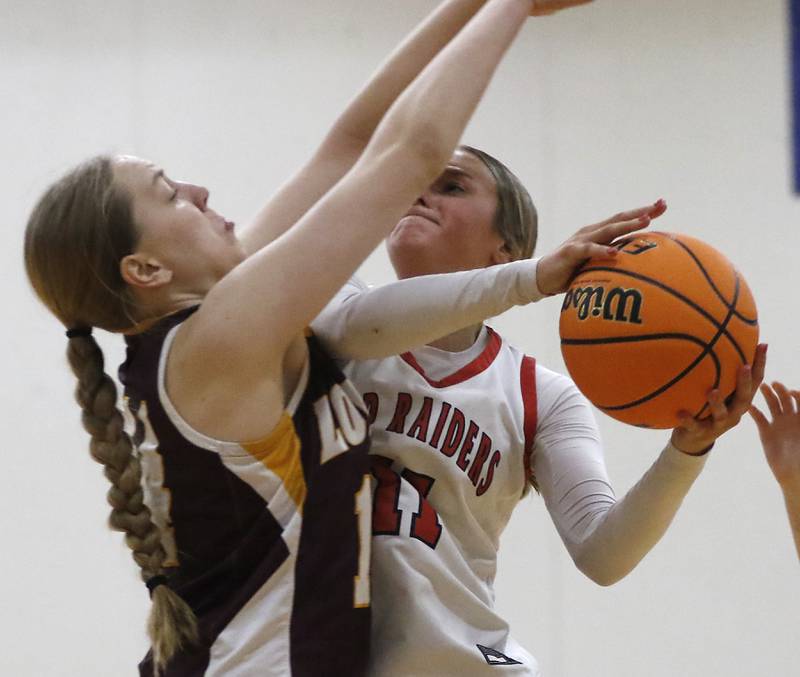 Huntley's Anna Campanelli os fouled by Loyola Academy's Emily Naraky as she drives to the basket during the IHSA Class 4A Gurnee Warren Supersectional girls basketball game on Monday, March 3, 2025, at Warren Township High School in Gurnee.
