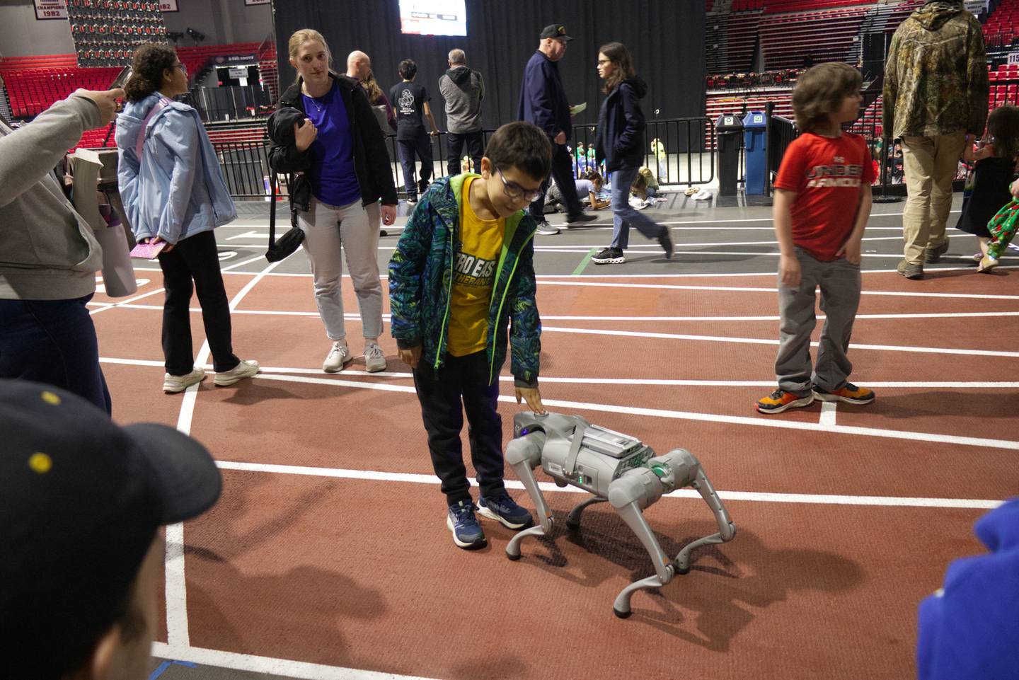 Demonstrations of two robotic dogs, including this one, by NIU engineering students were a big hit at the FIRST Tech Challenge State Championship on March 7, 2026, in DeKalb. These AI-assisted machines, used within the mechatronics program in the College of Engineering and Engineering Technology (CEET), are research platforms for potential applications such as helping individuals with sensory issues navigate their homes and communities. (Photo by Jerry Stamos)