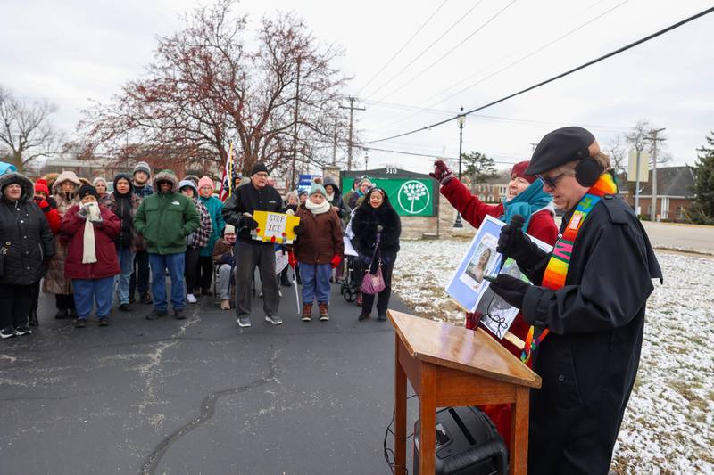 Pastors Robert Bushey, center, and Lana Robyne lead a crowd of about 100 in a song during an ICE Out for Good protest and vigil at The Grow Center in Bourbonnais on Sunday, Jan. 11, 2026. The event was planned in the wake of the shooting death of Renee Nicole Good by an ICE agent on Jan. 7 in Minneapolis, Minn.