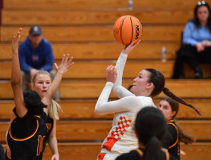 Minooka’s Madelyn Kiper shoots while surrounded by four Montini defenders during a Montini Christmas Tournament game on December 22, 2025 at Montini Catholic High School in Lombard.