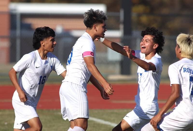 Larkin’s Adrian Diaz, center, is greeted by the Royals  after scoring a first-half goal against Huntley in boys soccer regional action at South Elgin on Saturday.
