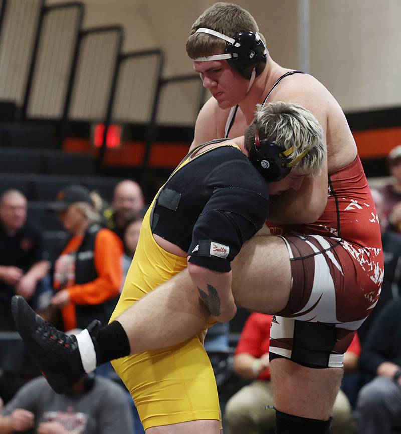 Lena-Winslow’s Jeremiah Luke lifts Erie-Prophetstown’s Caleb Rayner in the 285 pound first place match Saturday, Feb. 14, 2026, during the Class 1A wrestling sectionals in Byron.