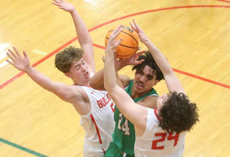 L-P's Marion Persich grabs a rebound over Streator's Isaish Weibel and teammate Jacob Hagle during the Class 3A Regional title game on Friday, Feb. 28, 2025 in Sellett Gymnasium at L-P High School.