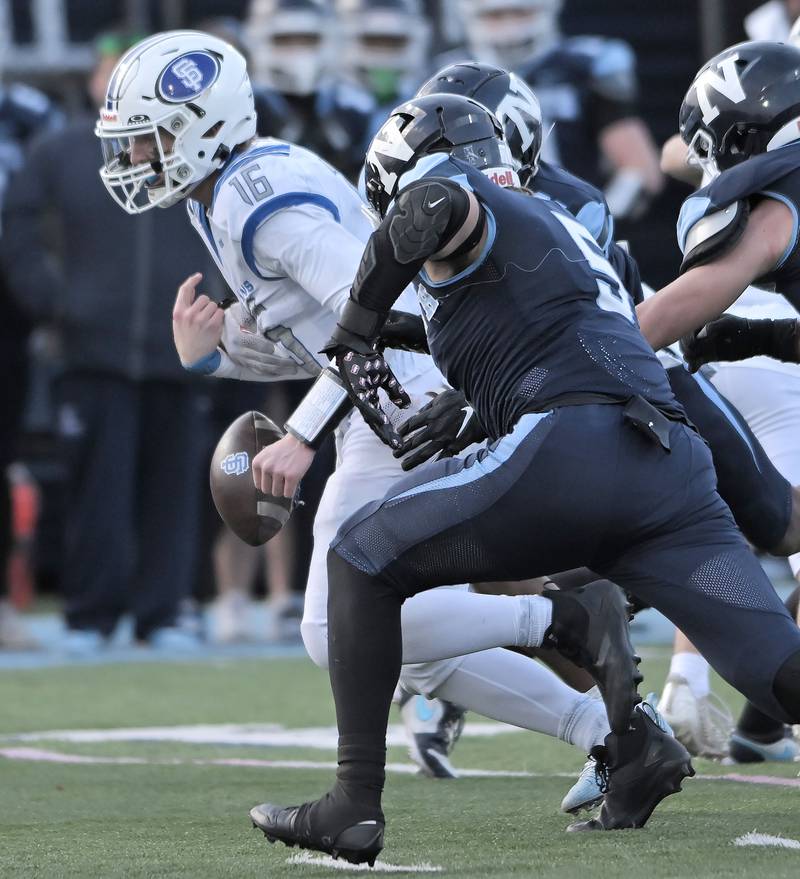 St. Francis quarterback Brady Palmer has the ball knocked loose as he scrambles late in the loss to Nazareth in the IHSA Class 5A state semifinal football game in La Grange on Saturday, Nov. 23, 2024.